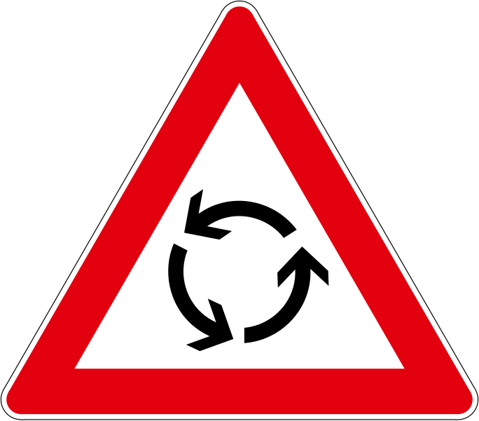 The traffic sign warns the approach of the intersection with a roundabout.