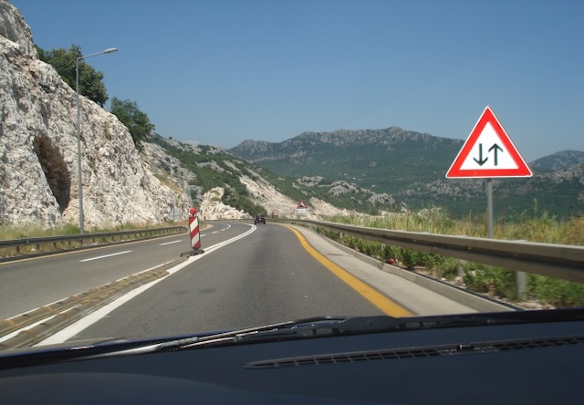 In this situation, the road starts from the sign where the traffic is conducted in two way.