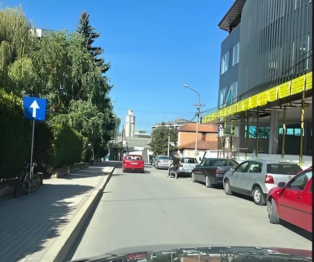 On this road, traffic is carried out in one direction only, some pedestrians can get out of the parked cars onto the road.